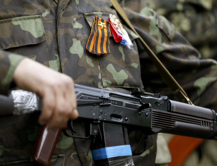 Soldier holding an assault rifle with medals