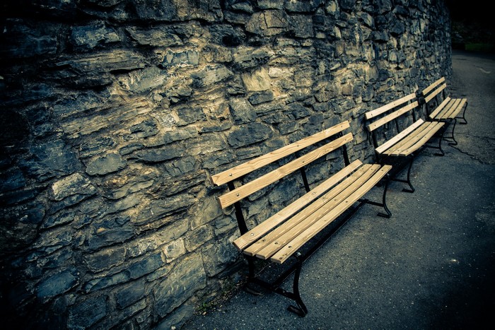 Stone wall with wooden benches