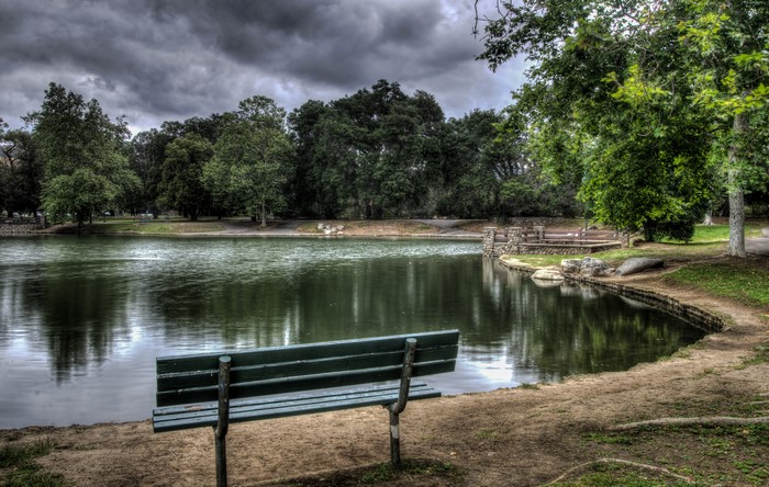 Bench by a lake in Irvine Regional Park, California