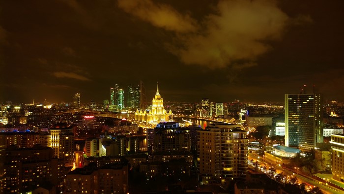 Moscow cityscape at night with illuminated buildings and skyscrapers