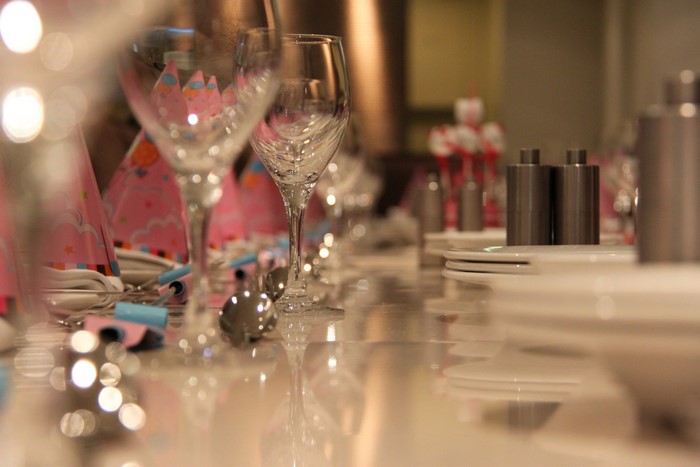 Table setting with party hats and wine glasses
