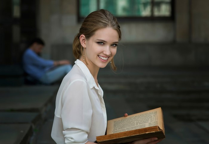 Woman reading a book outdoors