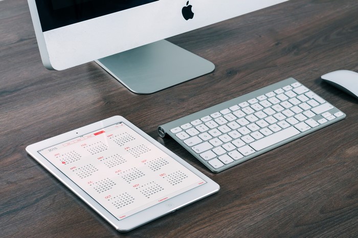 Apple iMac, Keyboard, Mouse, and iPad with 2015 Calendar