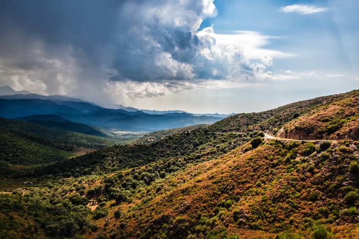 Mountainous landscape in Corsica, France under stormy clouds