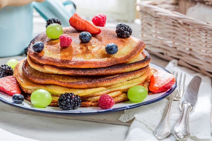 Pancakes with fresh berries and grapes