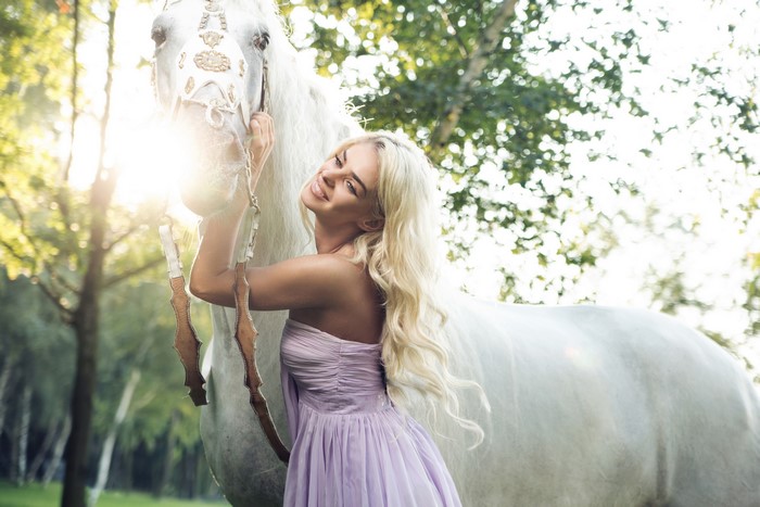 Blonde girl with white horse