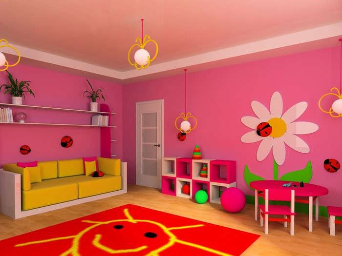 Children's room with pink walls, yellow sofa, and toys