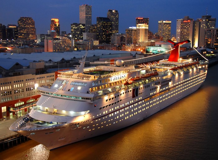 Carnival Fantasy cruise ship docked at night in a city