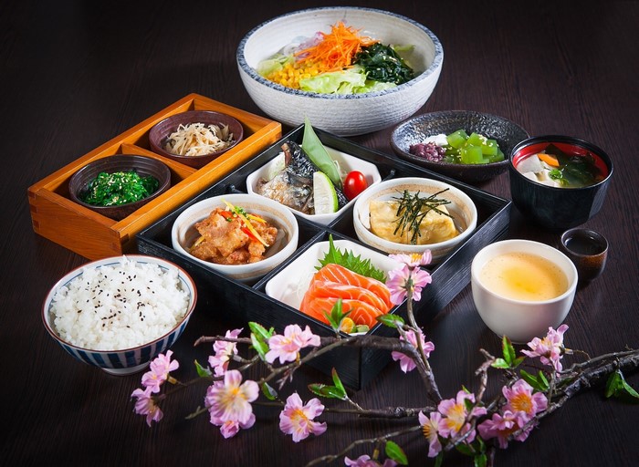 Japanese bento box with salmon, rice, and soup