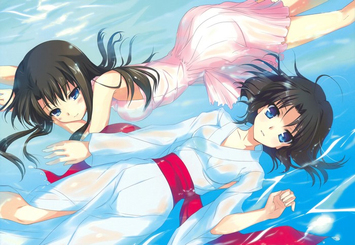 Two girls in white and pink dresses floating in water