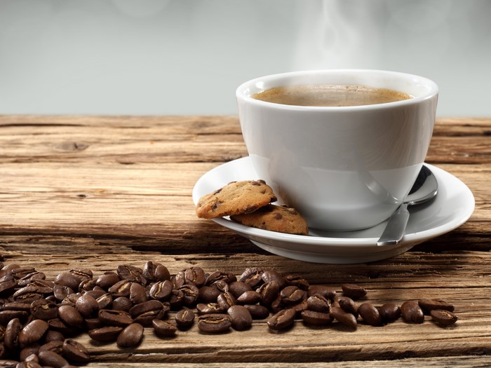 Coffee cup with cookies and coffee beans
