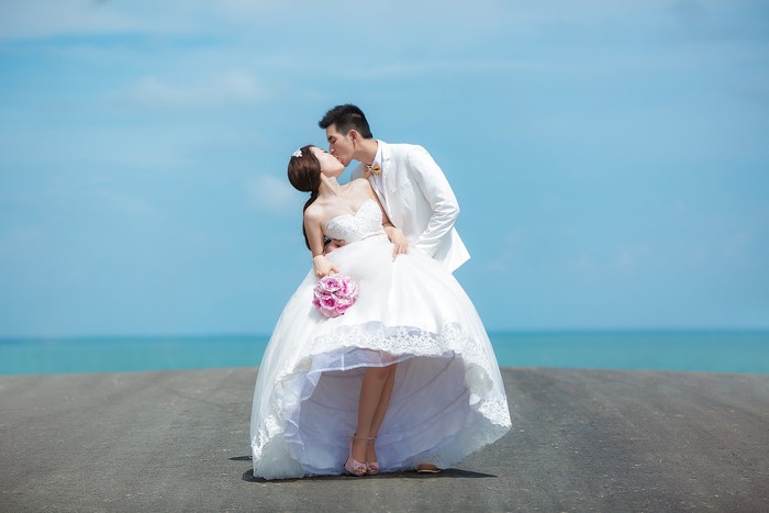 Bride and Groom kissing on a beach
