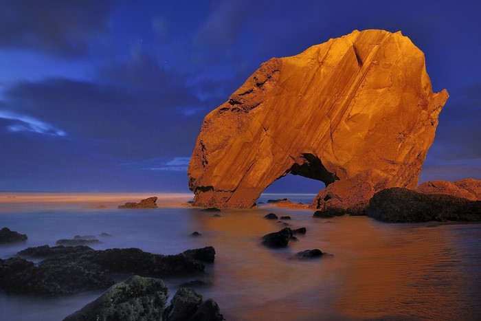 Penedo do Guincho rock arch at dusk, Portugal