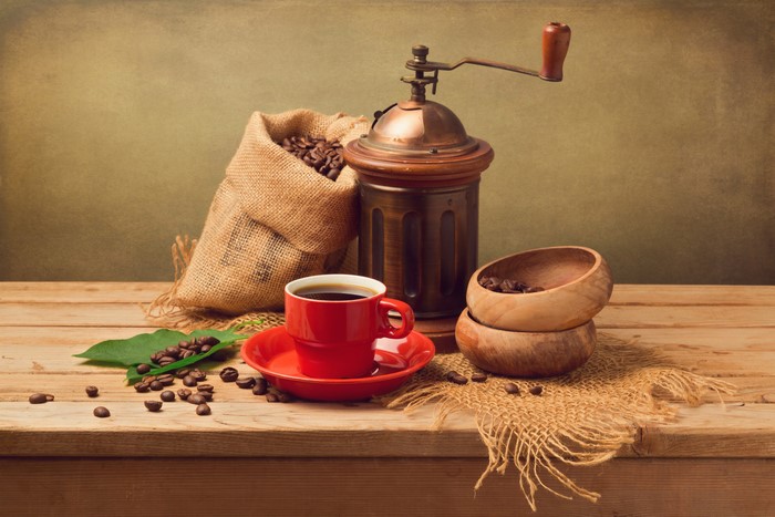 Still-life with coffee mill, cup, and coffee beans