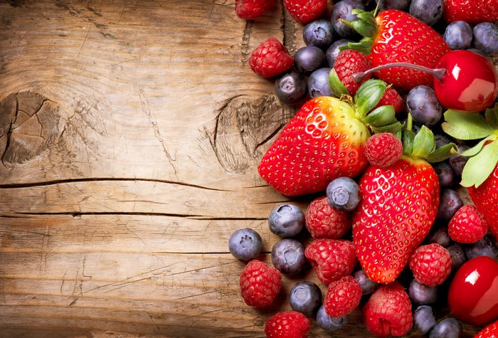 Assortment of Fresh Berries and Cherries on Wood