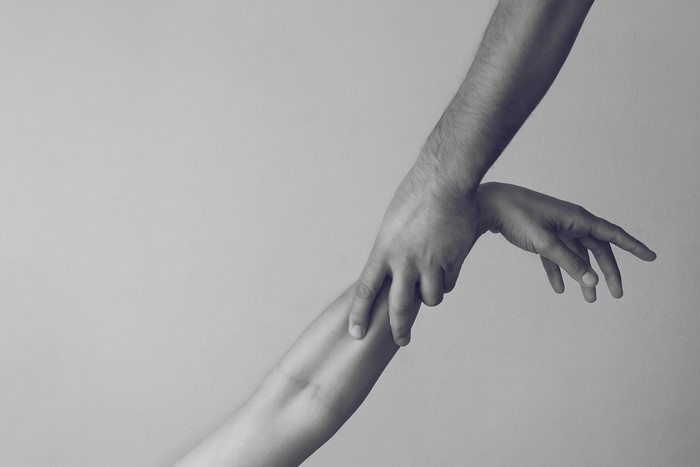 Two hands touching each other