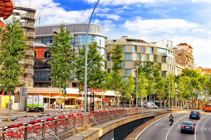 Barcelona street with modern buildings and bike rentals