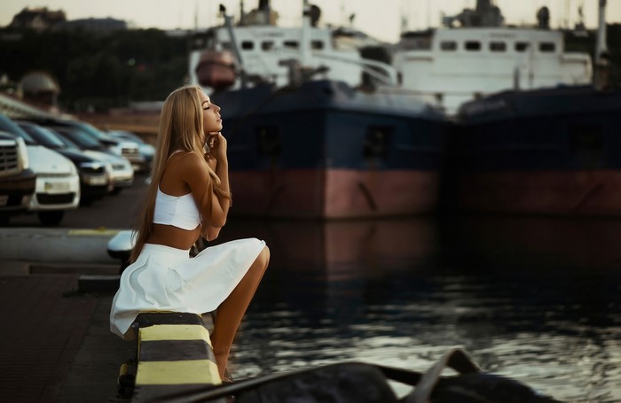 Blonde girl in white dress at Odessa marina