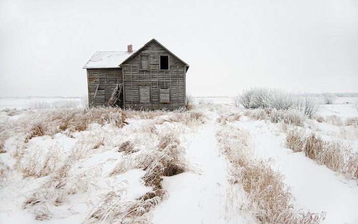 Abandoned wooden house in a snowy landscape