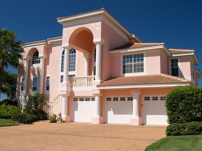 Pink Mediterranean Mansion with Arches and Garages