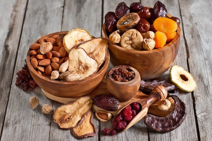 Assortment of dried fruits and nuts in wooden bowls