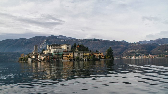 Island village on Lake Orta, Italy, with mountains