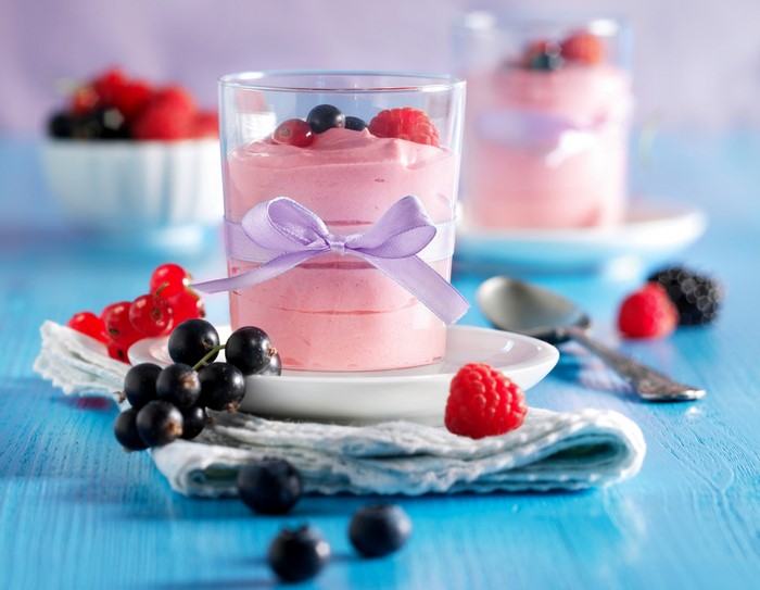 Cream mousse dessert with berries in a glass