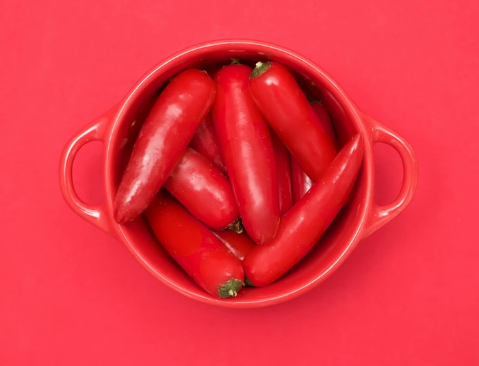 Red chili peppers in a red bowl