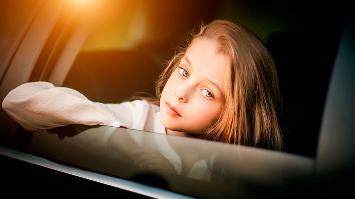 Girl looking out of a car window