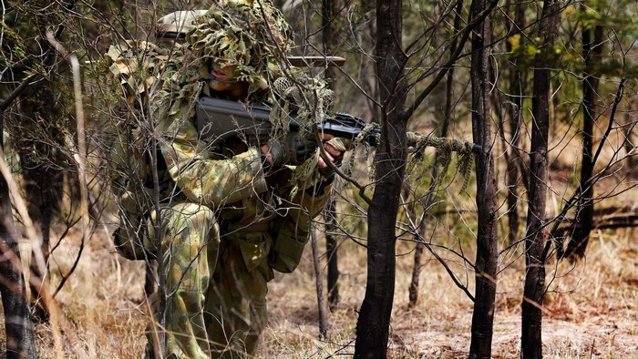 Australian soldiers in camouflage with sniper rifle