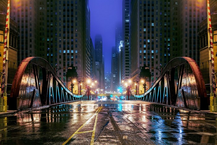 Chicago city bridge at night with wet street