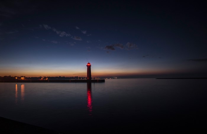Lighthouse at dusk over the sea