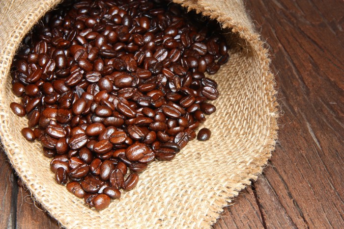 Coffee beans spilling from a burlap sack