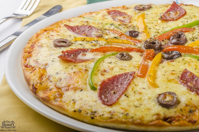 Close-up of a sausage and vegetable pizza