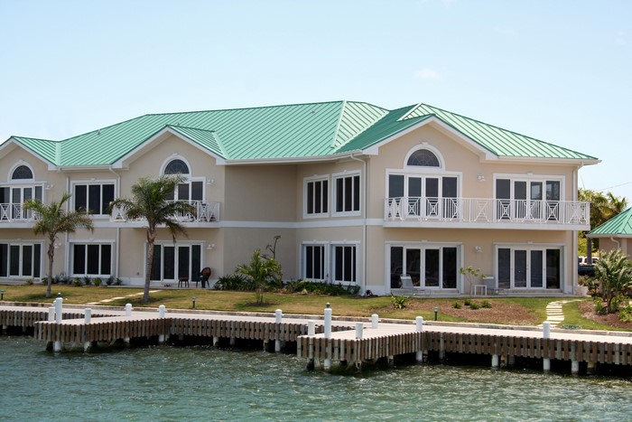 Waterfront houses with green roofs and a wooden dock
