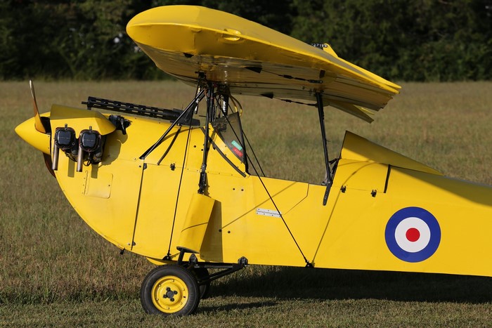 Yellow biplane with machine guns and roundel