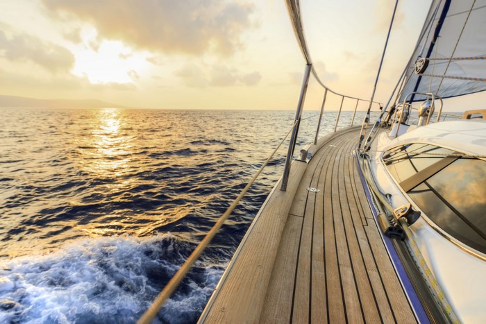 Yacht sailing on the sea at sunset