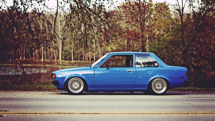 Blue Toyota Celica parked on the side of a road