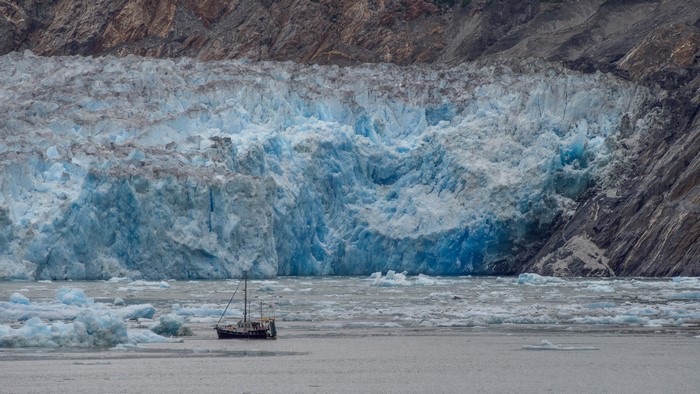 Boat near a glacier with mountains