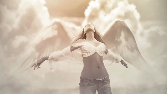 Woman with angel wings in clouds