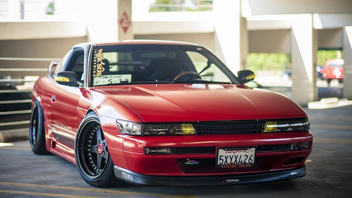 Red Nissan Silvia S13 with custom wheels