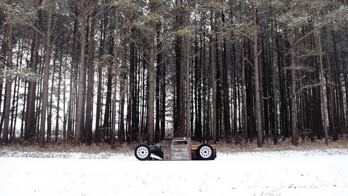 Rat rod truck in a snowy forest