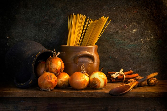 Still life with onions, spaghetti, and spices