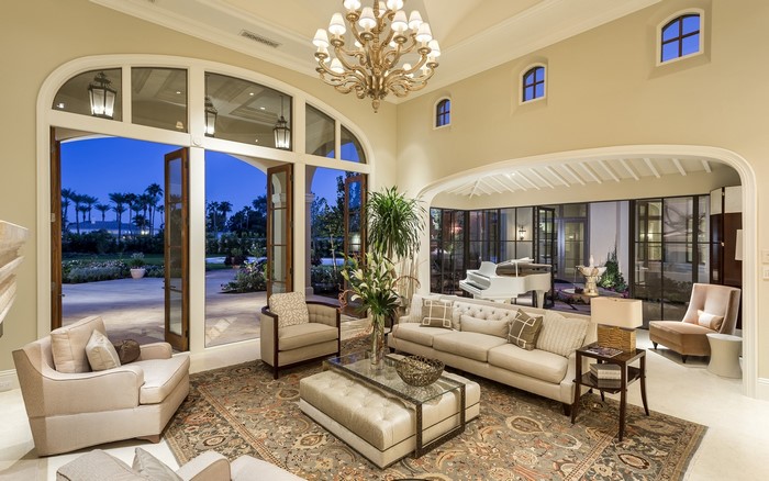 Living room with white grand piano and large windows
