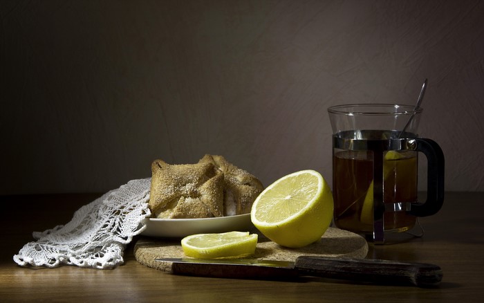 Tea with lemon and pastries on a table