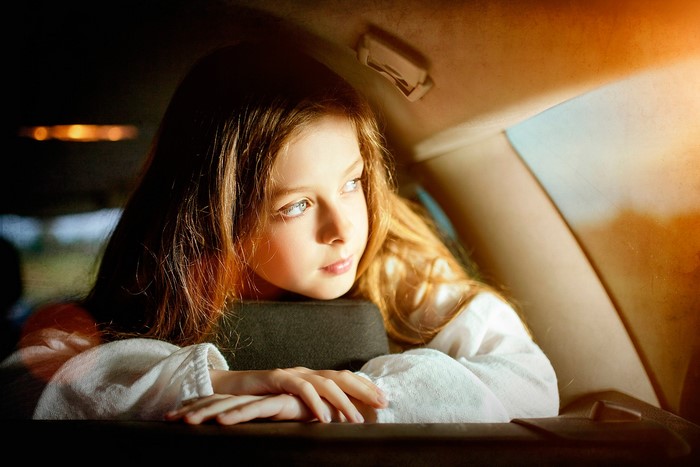 Girl looking out of a car window