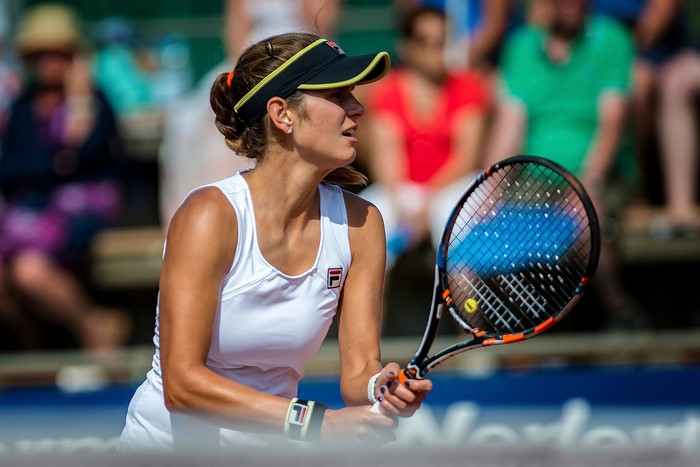 Woman playing tennis with a racket