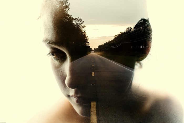 Double exposure of a girl's face and a road