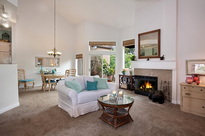 Living room with fireplace, sofa, and dining table