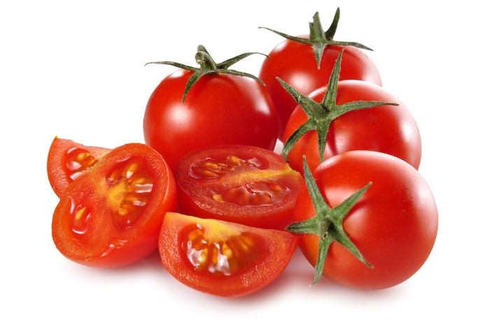 Whole and sliced cherry tomatoes on a white background